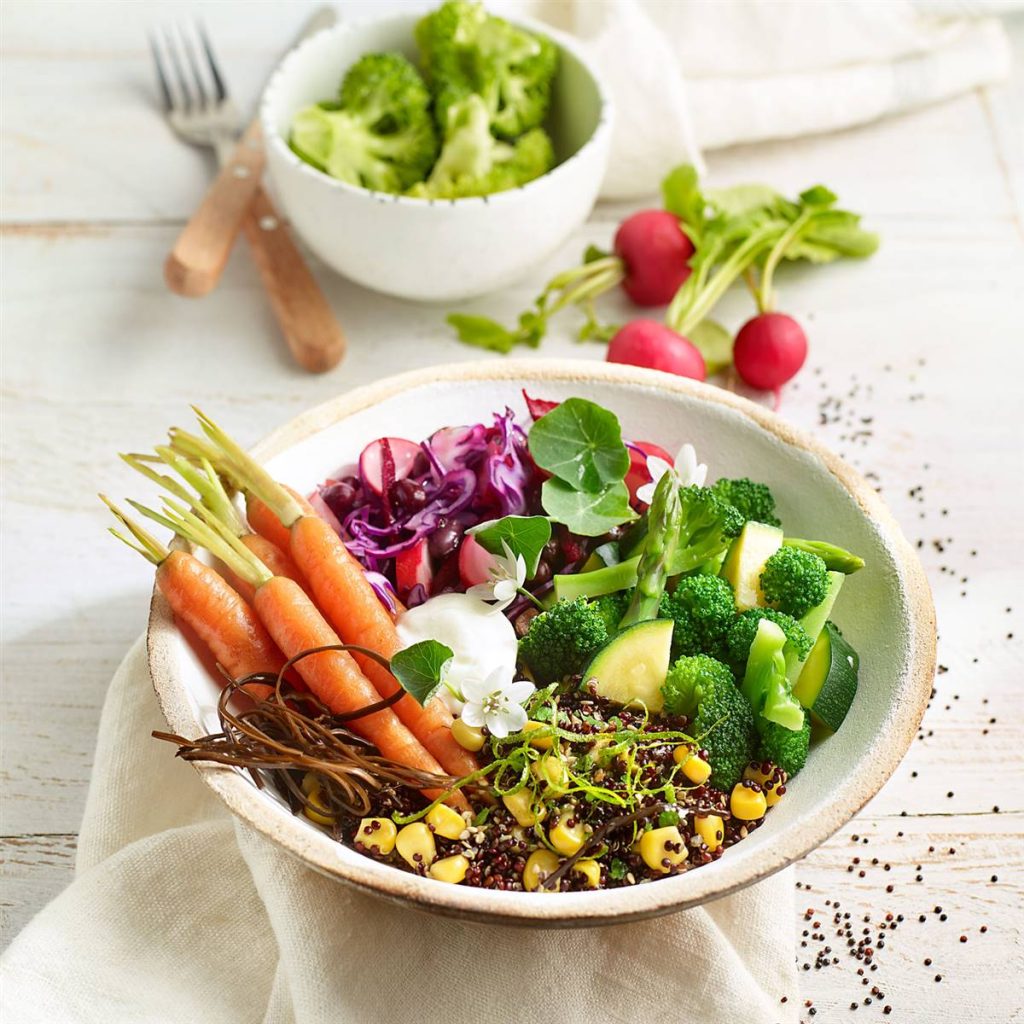 Crispy quinoa Buddha bowl with steamed vegetables and icings
